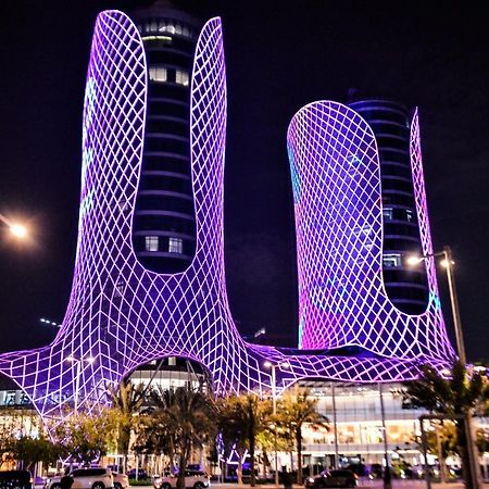 Century Marina Hotel - Lusail Εξωτερικό φωτογραφία The Al Hamra Towers at night